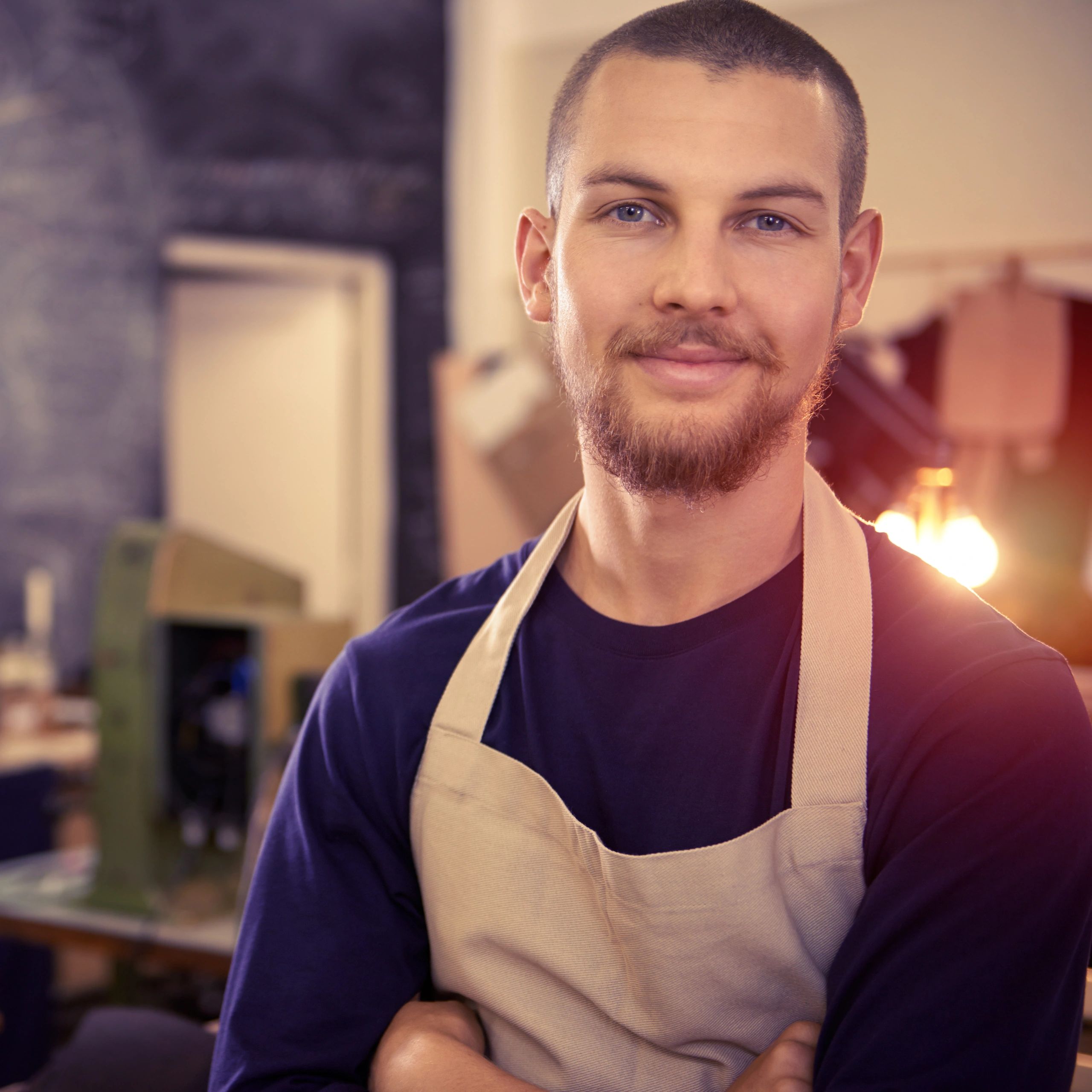 Professional standing in a workshop representing the business team